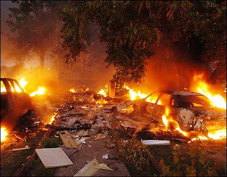 Derailment caused fires, photo shows cars engulfed in flames.